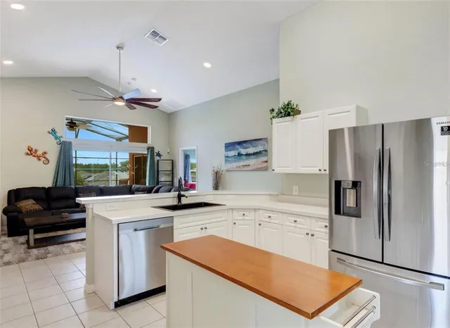 a kitchen that has a sink a stove and a refrigerator