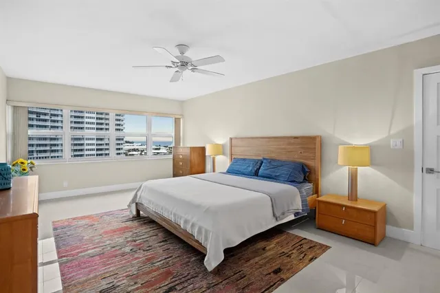 a bedroom with bed and wooden floor