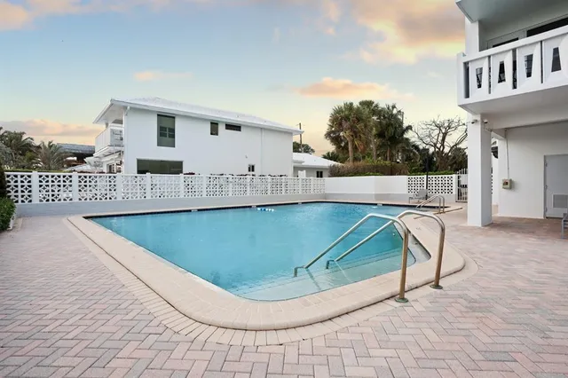a view of building with yard and swimming pool