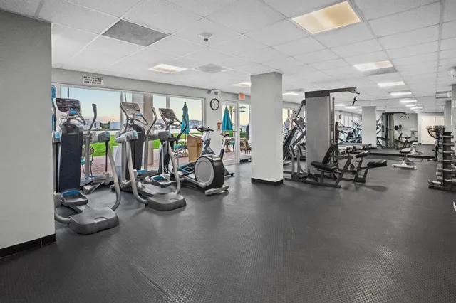 a dining area with stainless steel appliances lots of white furniture a dining table and chairs