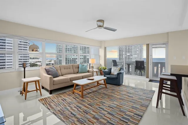 a living room with furniture and kitchen view