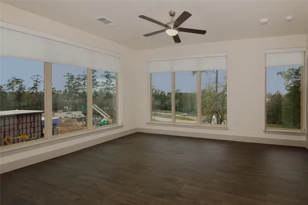 a view of room with window and wooden floor