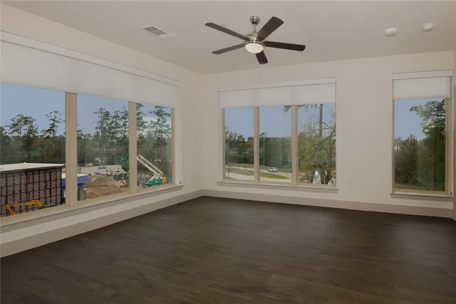 a view of room with window and wooden floor