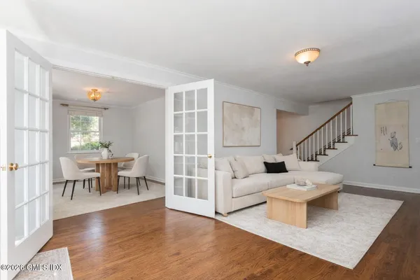 a living room with furniture and a wooden floor