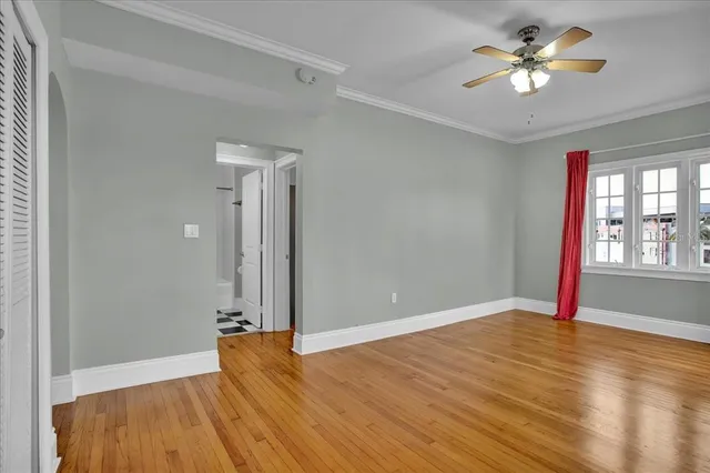 wooden floor in an empty room with a window