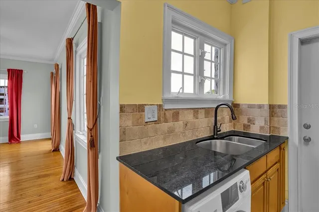 a kitchen with granite countertop a sink and cabinets