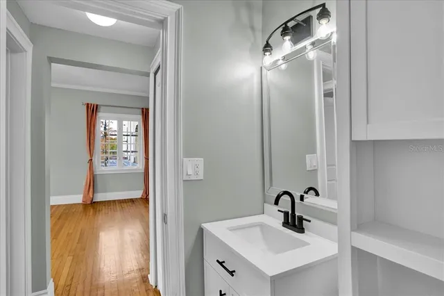 a bathroom with a sink mirror and shower