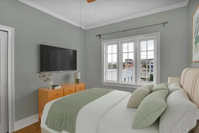 a bedroom with a bed and a flat screen tv