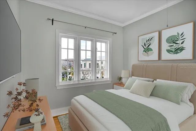 a bedroom with a bed and a painting on the wall