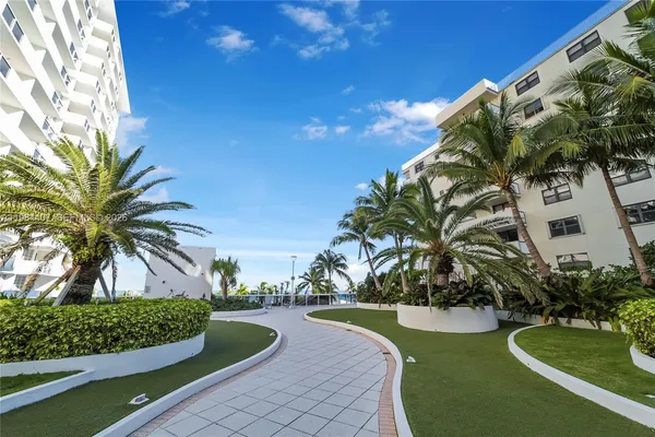 a view of a tall building with a palm tree