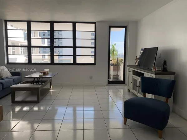 a living room with furniture and a flat screen tv
