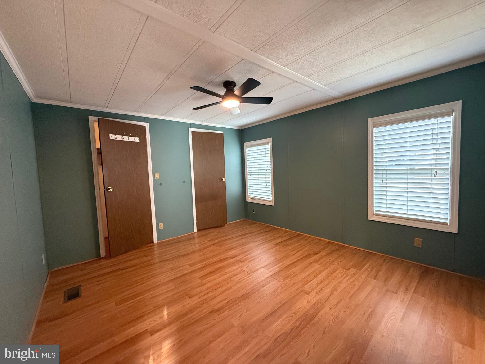 386 Indian Way Buena, NJ 08310 - Photo 29 of 53 a view of an empty room with window and wooden floor