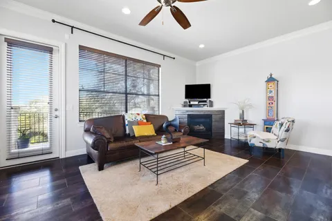 a living room with furniture a fireplace and a flat screen tv