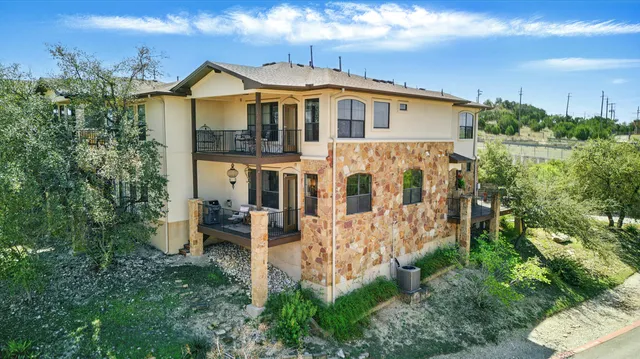 a view of a house with yard and sitting area