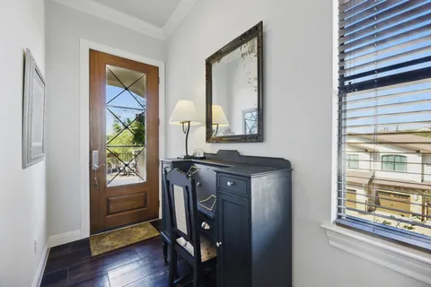 a view of an entryway with wooden floor and door