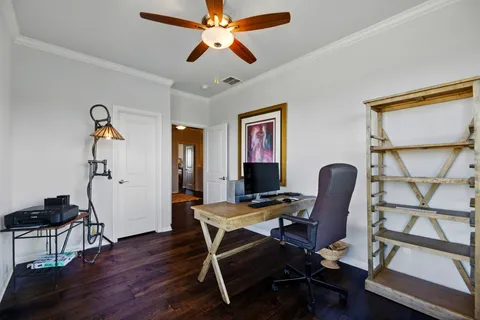 a view of a workspace with furniture and a window