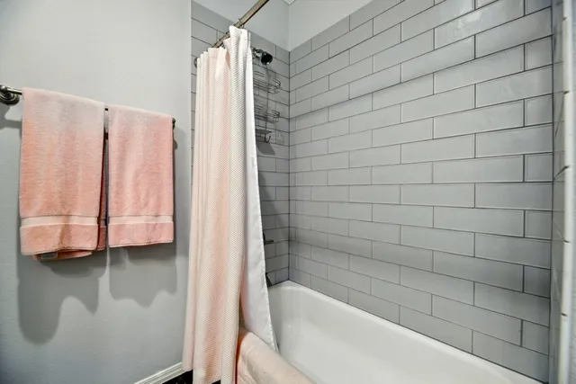 a bathroom with a bathtub and a shower
