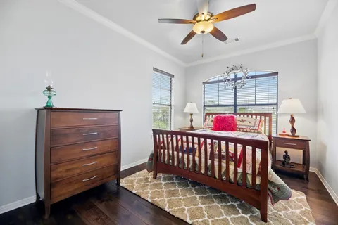 a bedroom with furniture and a baby crib