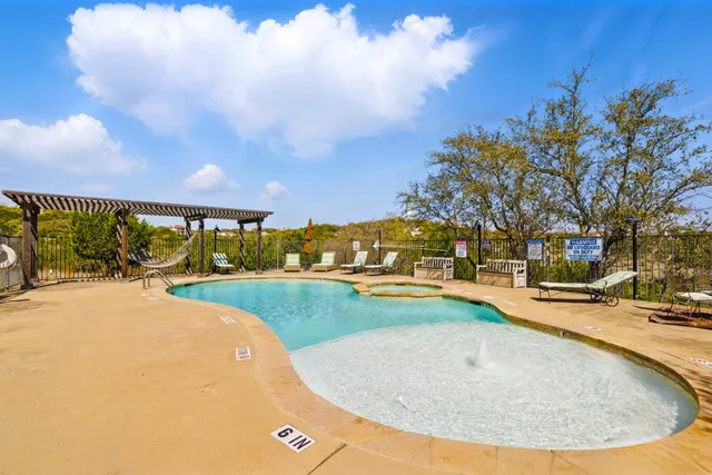 a view of a swimming pool with an outdoor seating and a yard
