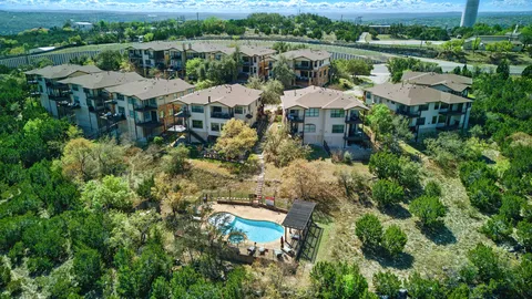 an aerial view of a house with yard swimming pool and outdoor seating
