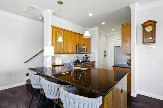 a kitchen with granite countertop a sink cabinets and window