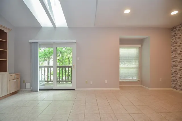 a living room with furniture a rug and a window