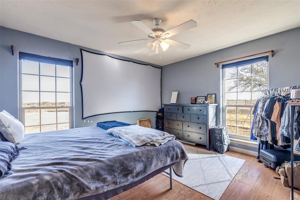 453 County Road 371 Anna, TX 75409 - Photo 21 of 26 a bedroom with a bed and a large window