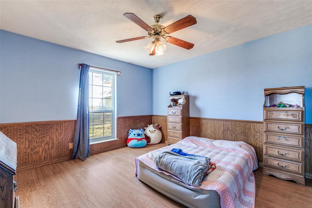 453 County Road 371 Anna, TX 75409 - Photo 22 of 26 a bedroom with a bed and a window