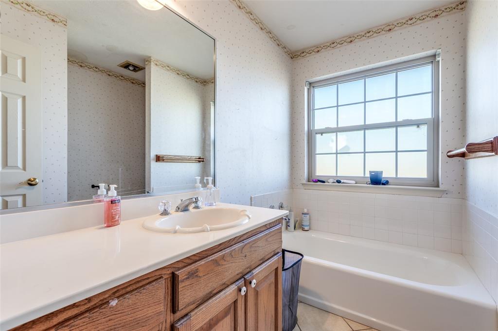 453 County Road 371 Anna, TX 75409 - Photo 23 of 26 a bathroom with a tub sink and mirror