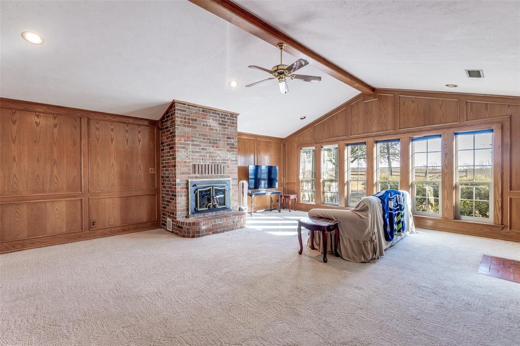 453 County Road 371 Anna, TX 75409 - Photo 7 of 26 a bed room with furniture and a fireplace