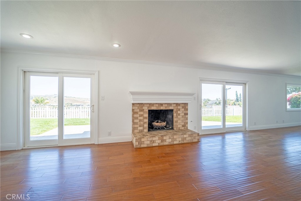 25276 Barque Way Dana Point, CA 92629 - Photo 13 of 61 an empty room with wooden floor and fireplace