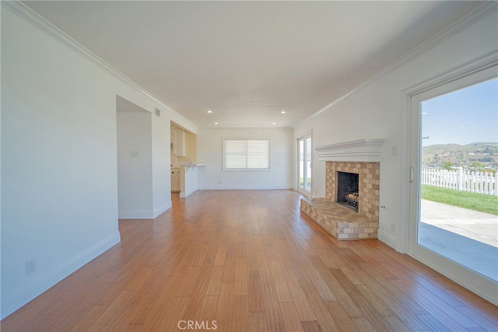 25276 Barque Way Dana Point, CA 92629 - Photo 17 of 61 a view of empty room with wooden floor and fireplace