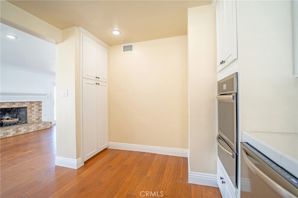 25276 Barque Way Dana Point, CA 92629 - Photo 24 of 61 a view of an empty room with wooden floor and a fireplace
