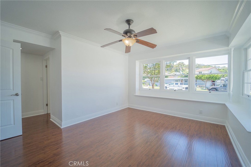 25276 Barque Way Dana Point, CA 92629 - Photo 27 of 61 an empty room with wooden floor ceiling fan and windows