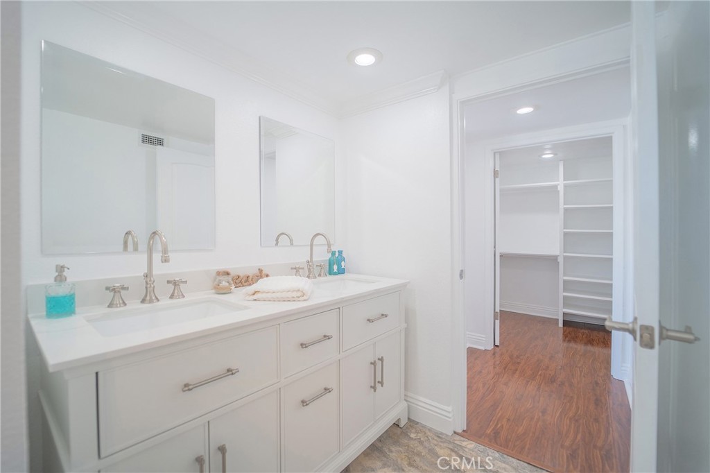 25276 Barque Way Dana Point, CA 92629 - Photo 35 of 61 a spacious bathroom with a double vanity sink a mirror and a shower