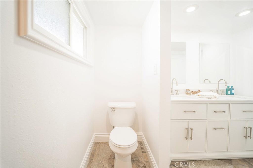 25276 Barque Way Dana Point, CA 92629 - Photo 36 of 61 a bathroom with a toilet a sink a mirror and vanity