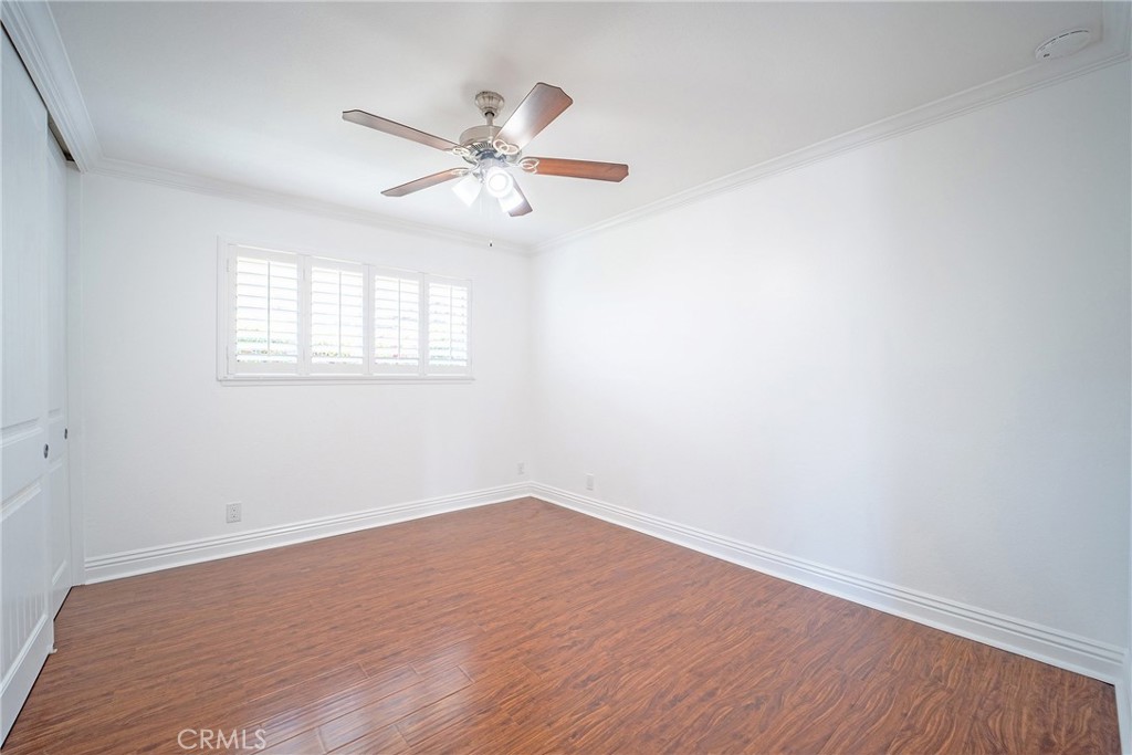 25276 Barque Way Dana Point, CA 92629 - Photo 40 of 61 an empty room with wooden floor fan and windows