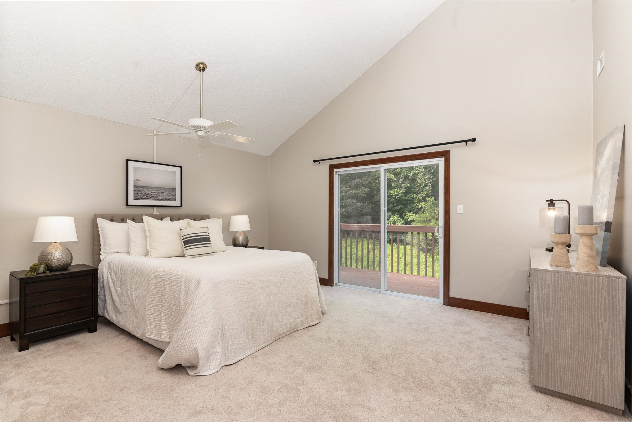 9413 Springdale Drive Raleigh, NC 27613 - Photo 11 of 24 a bedroom with a balcony a bed and a chandelier