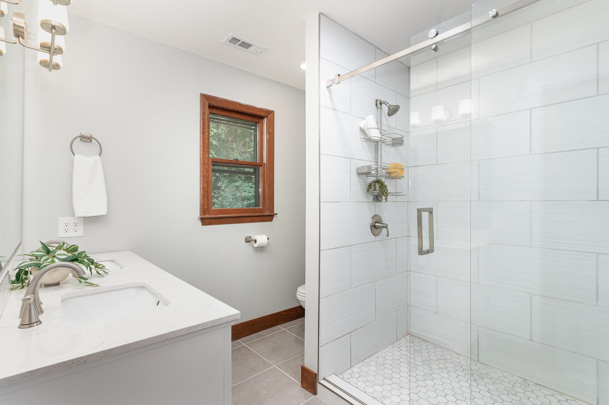 9413 Springdale Drive Raleigh, NC 27613 - Photo 13 of 24 a bathroom with a sink a toilet and shower