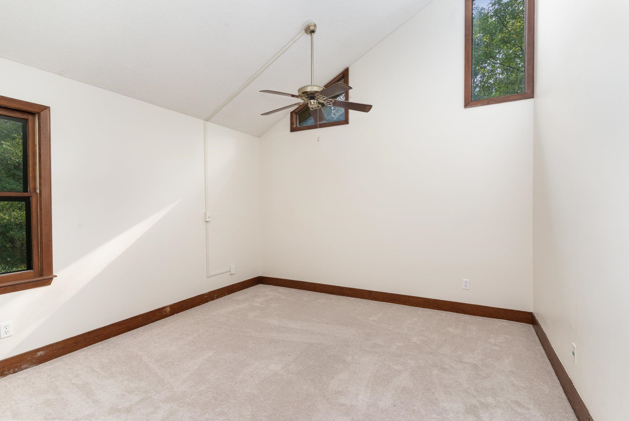 9413 Springdale Drive Raleigh, NC 27613 - Photo 15 of 24 an empty room with a window and a fan