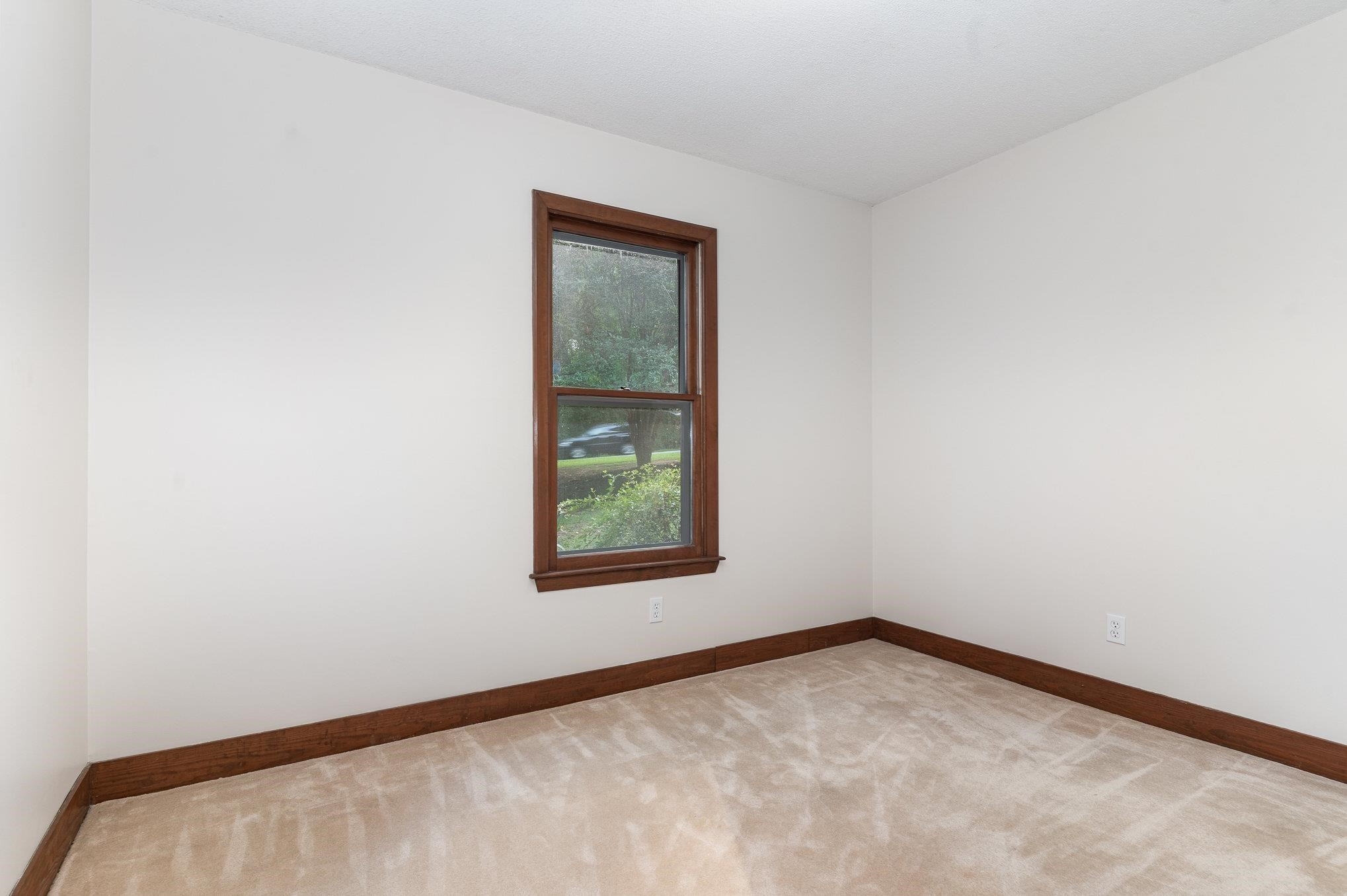 9413 Springdale Drive Raleigh, NC 27613 - Photo 19 of 24 an empty room with a window