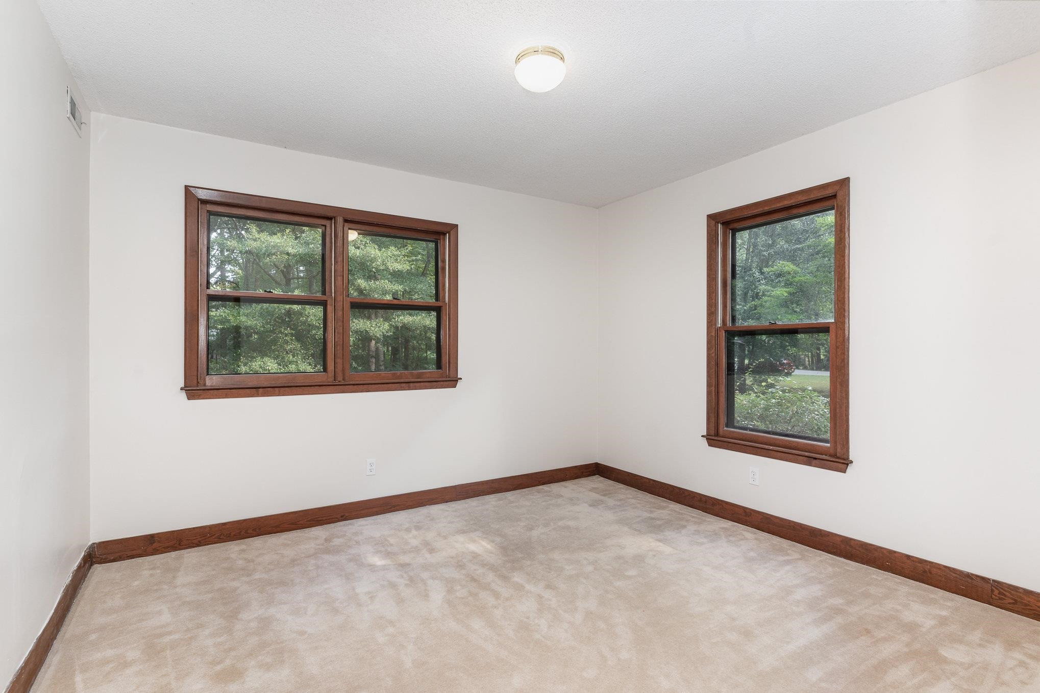9413 Springdale Drive Raleigh, NC 27613 - Photo 20 of 24 an empty room with a window