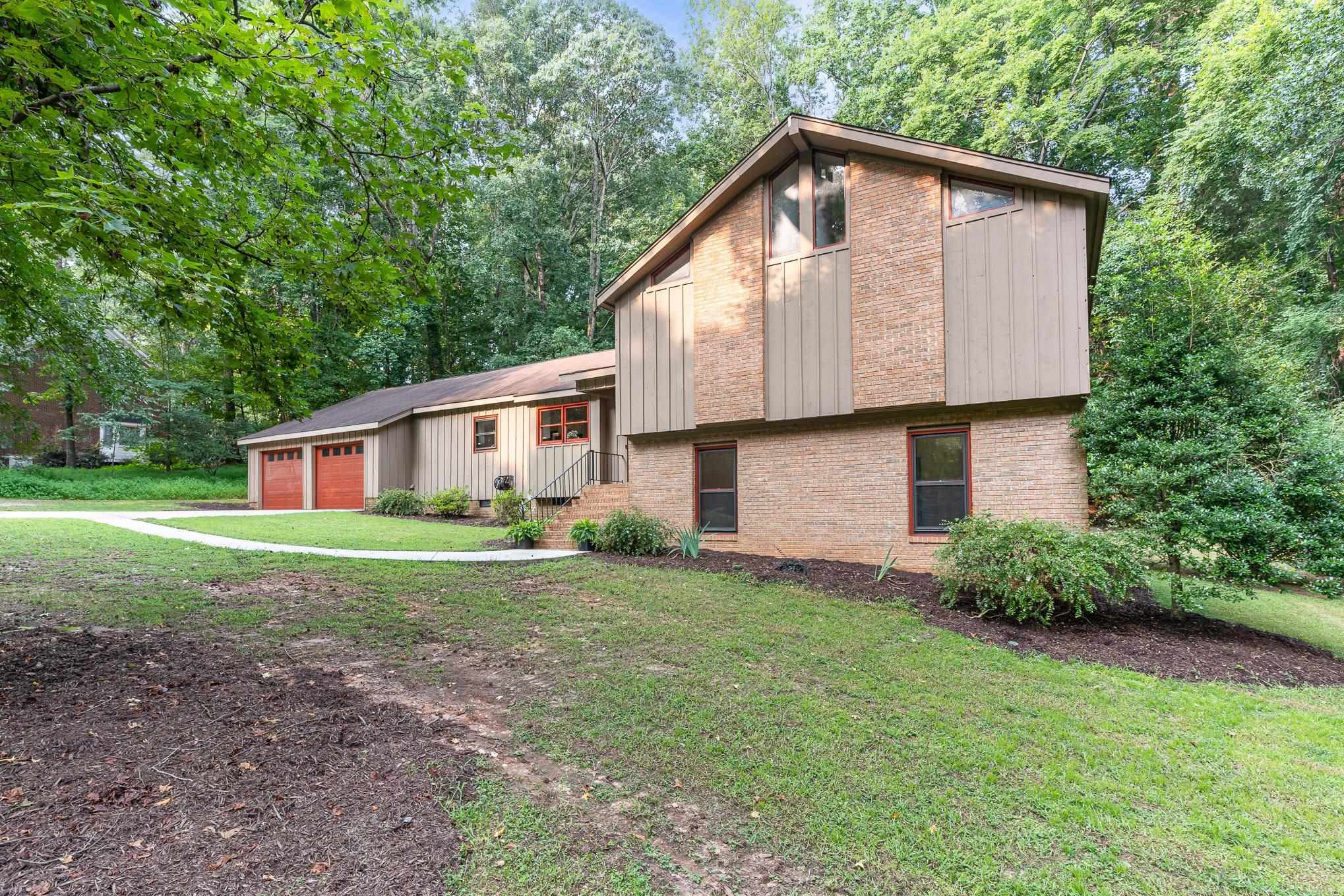 9413 Springdale Drive Raleigh, NC 27613 - Photo 2 of 24 a front view of house with backyard and green space