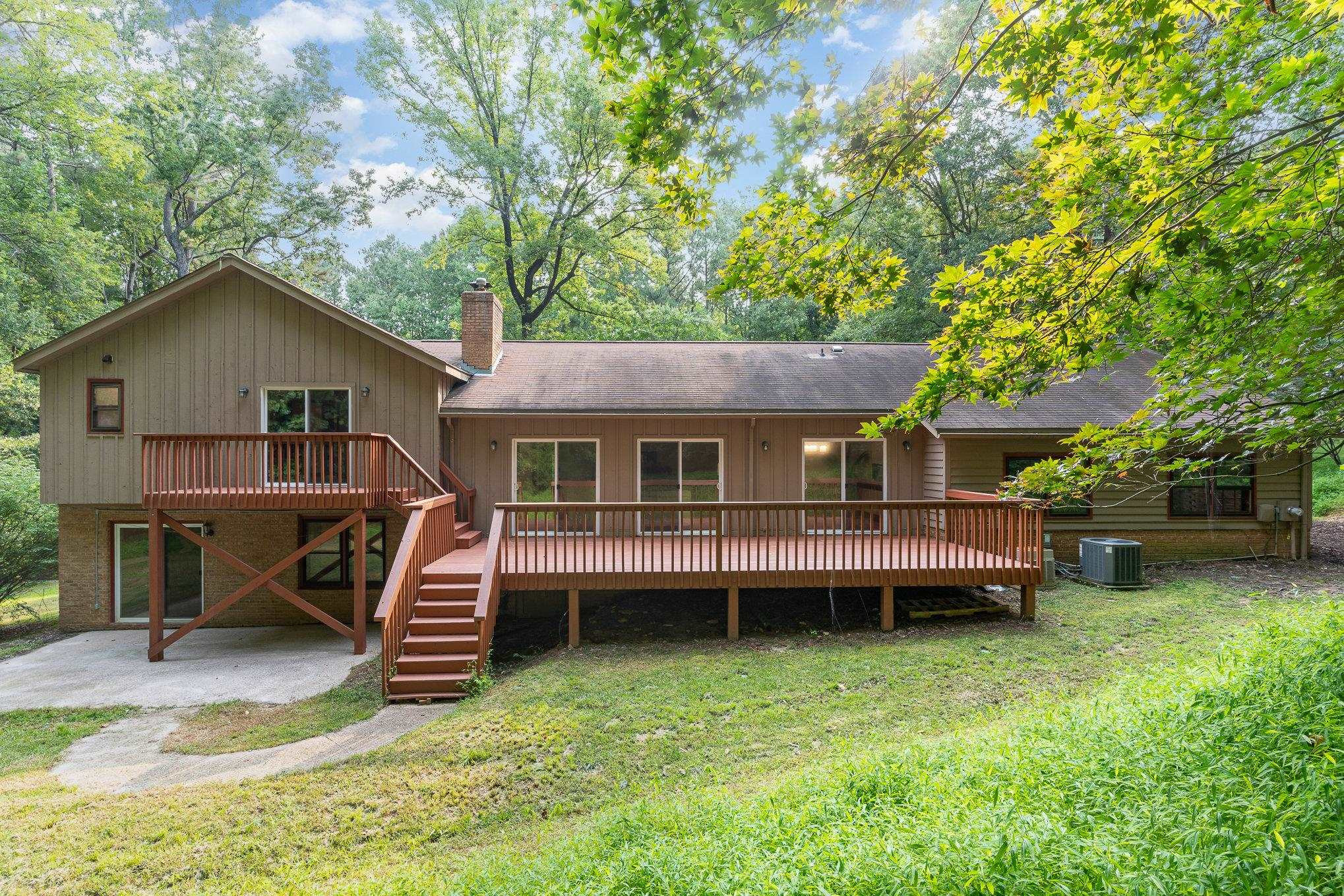 9413 Springdale Drive Raleigh, NC 27613 - Photo 23 of 24 a view of a house with a yard and sitting area