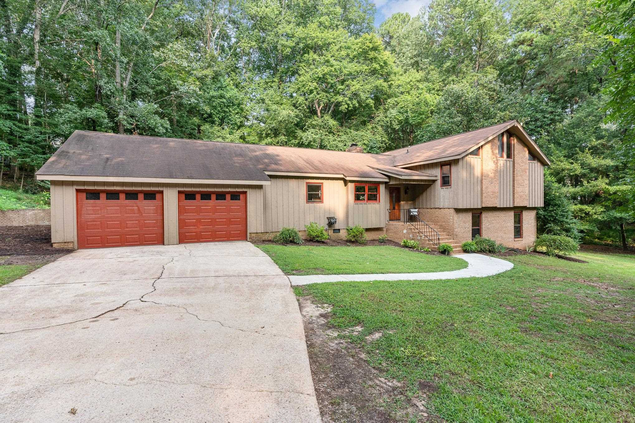 9413 Springdale Drive Raleigh, NC 27613 - Photo 3 of 24 a front view of a house with a yard and trees