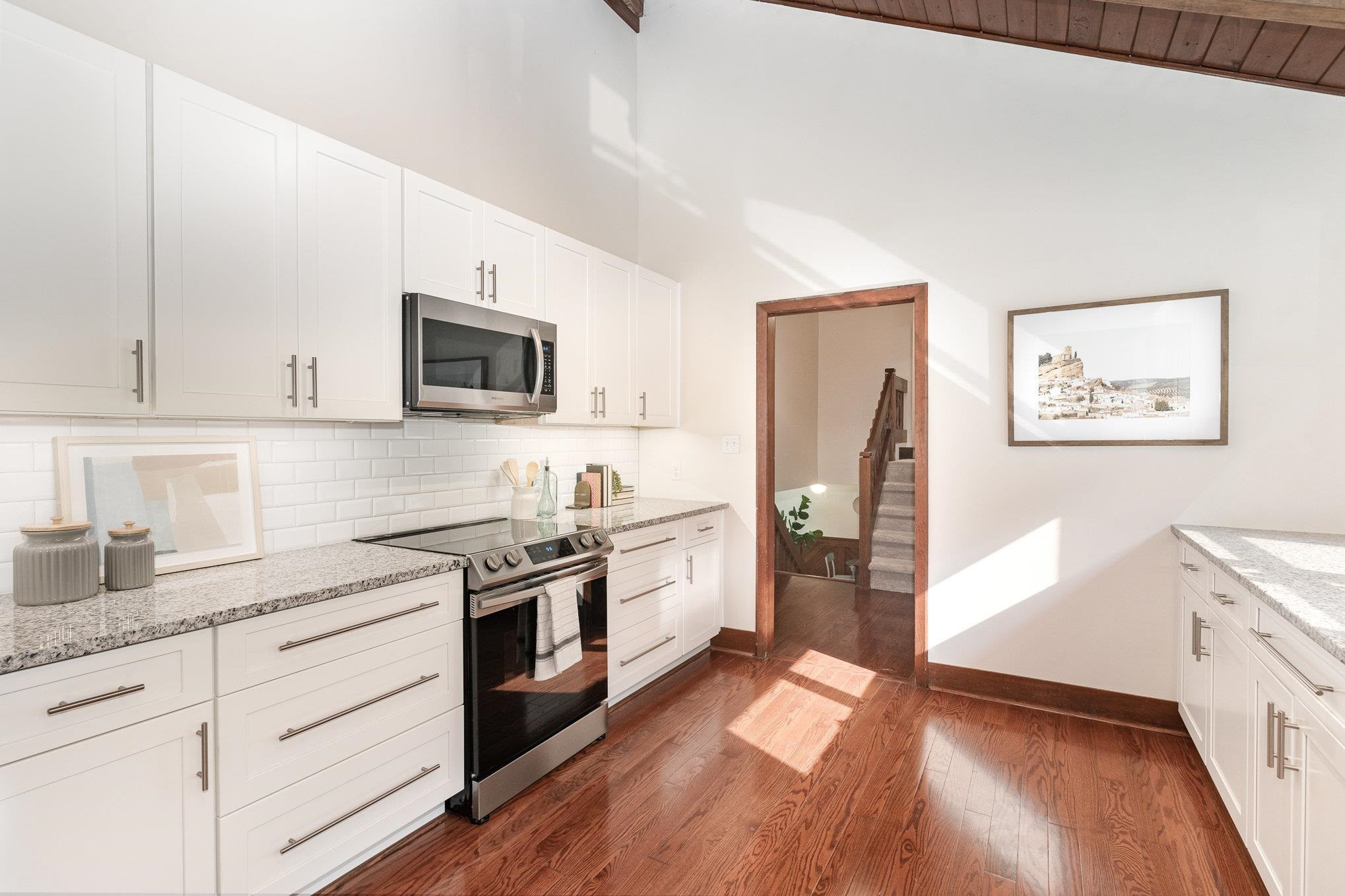 9413 Springdale Drive Raleigh, NC 27613 - Photo 6 of 24 a kitchen with granite countertop cabinets stainless steel appliances and a wooden floor