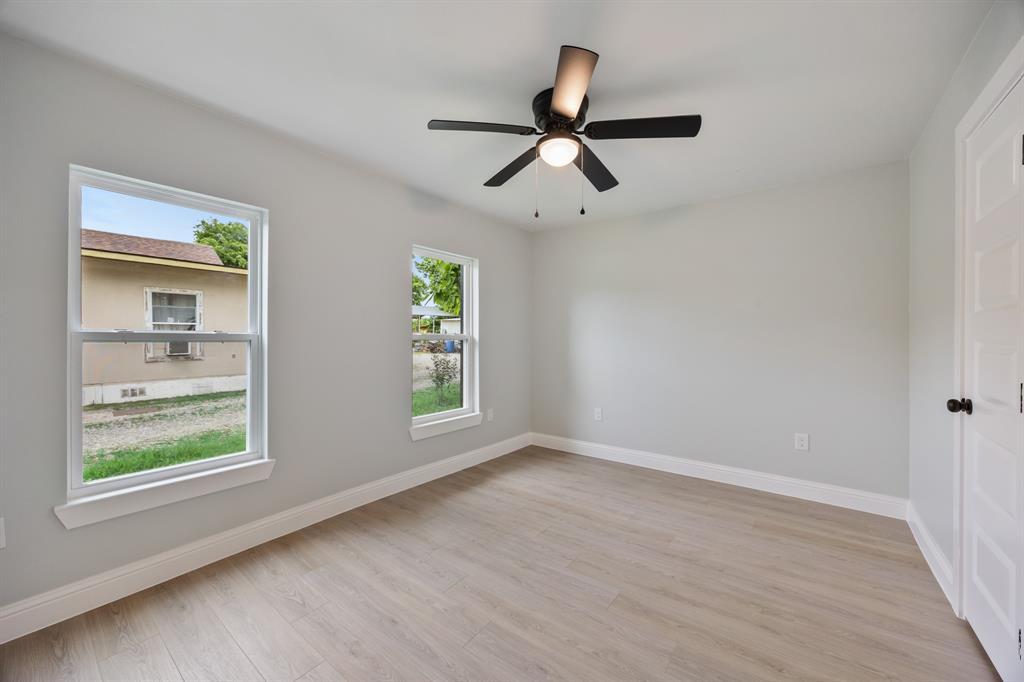 315 South Business Highway 78 Blue Ridge, TX 75424 - Photo 18 of 28 wooden floor in an empty room with a window