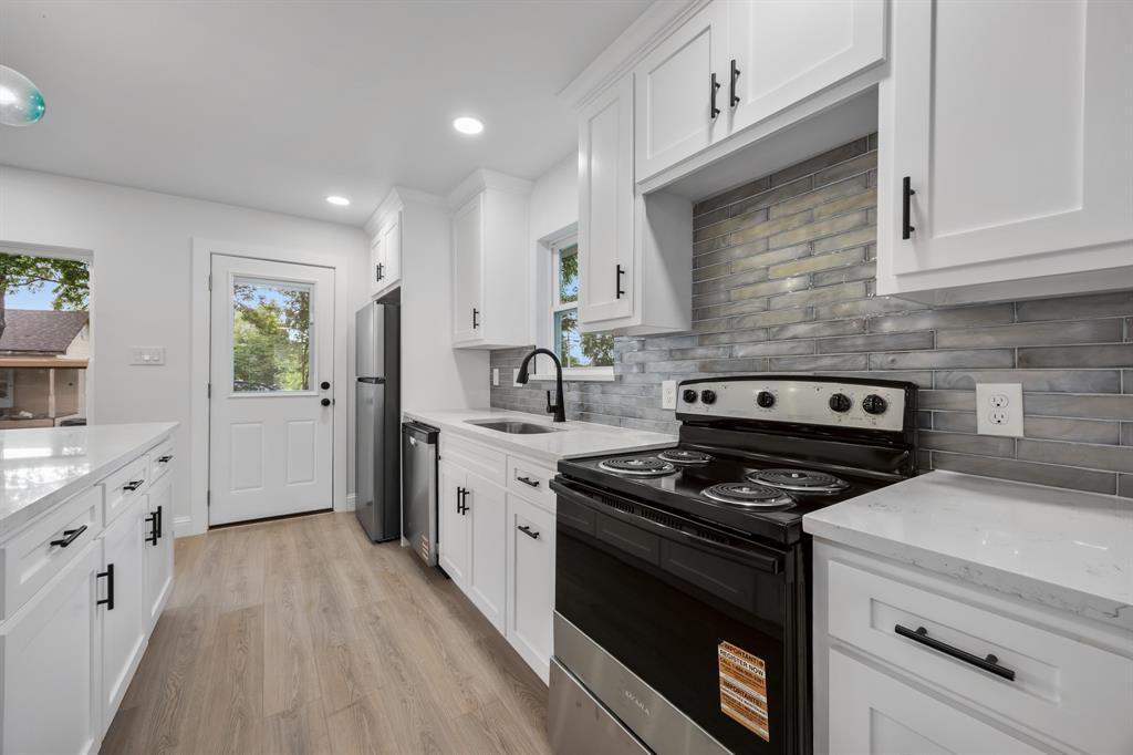 315 South Business Highway 78 Blue Ridge, TX 75424 - Photo 6 of 28 a kitchen with granite countertop cabinets stainless steel appliances and a wooden floor
