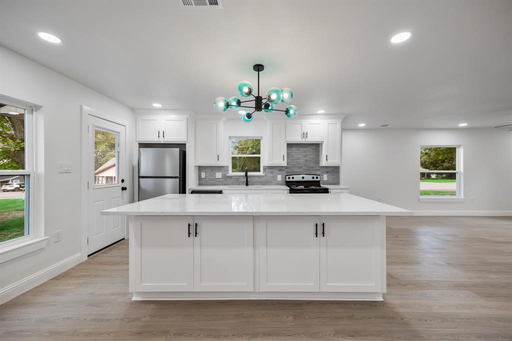 315 South Business Highway 78 Blue Ridge, TX 75424 - Photo 8 of 28 a kitchen with kitchen island white cabinets and refrigerator