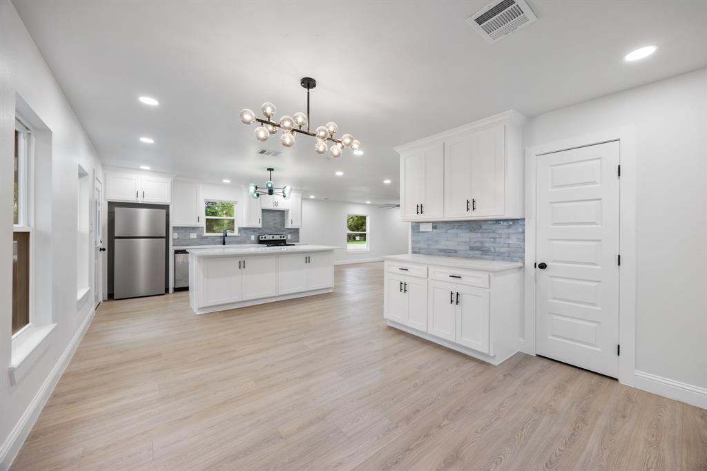 315 South Business Highway 78 Blue Ridge, TX 75424 - Photo 10 of 28 a large kitchen with cabinets wooden floor and stainless steel appliances